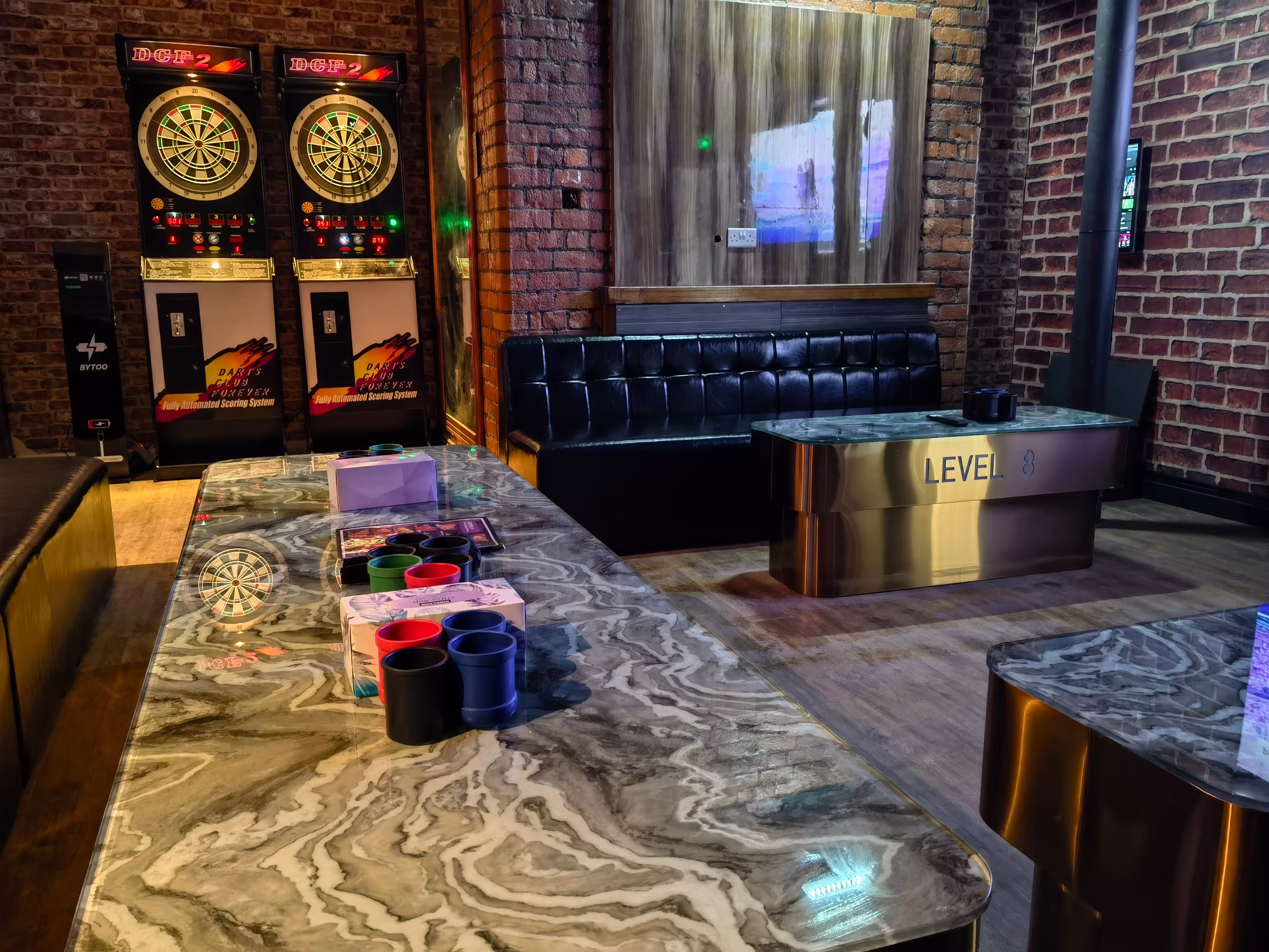 Large party KTV room with sofas, dart machines and arcade games at Level 8 KTV Manchester Gay Village